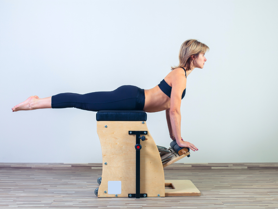 woman doing pilates on a pilates chair