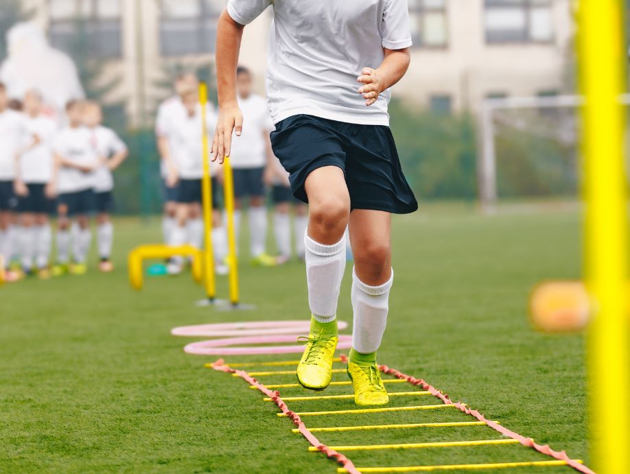 a soccer player training on agility ladder