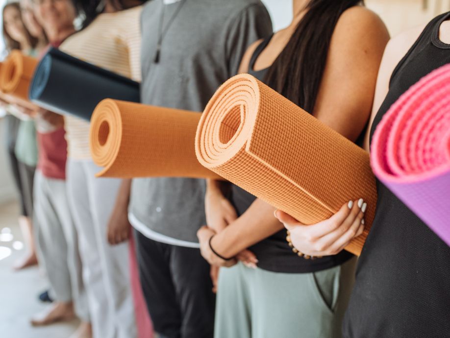 people carrying yoga mats
